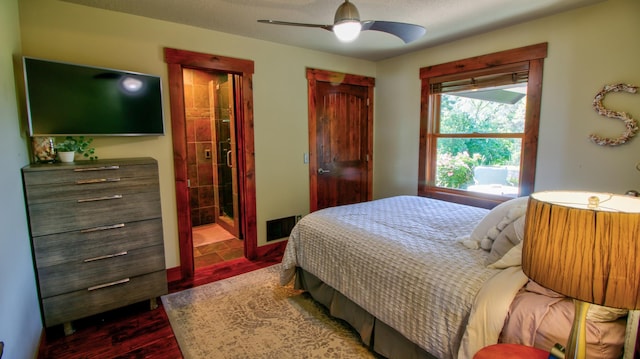 bedroom featuring ceiling fan, dark wood-type flooring, connected bathroom, and visible vents