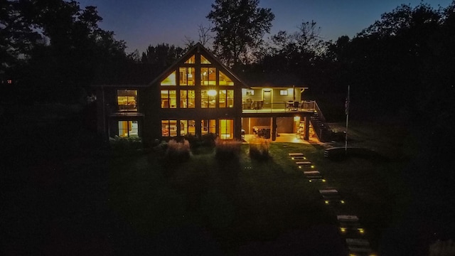 back of house at dusk featuring stairs