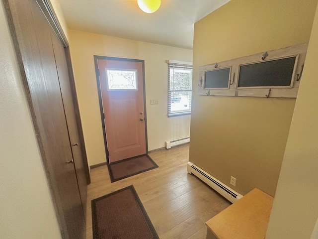 foyer featuring light hardwood / wood-style floors and a baseboard heating unit