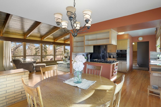 dining area with a notable chandelier, plenty of natural light, and light wood-style floors