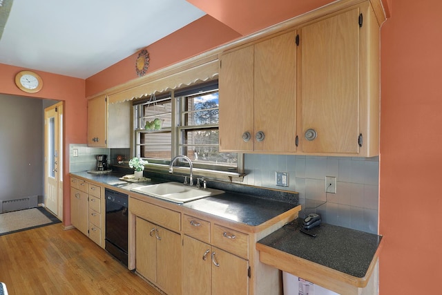 kitchen with light wood-type flooring, a sink, black dishwasher, tasteful backsplash, and baseboard heating