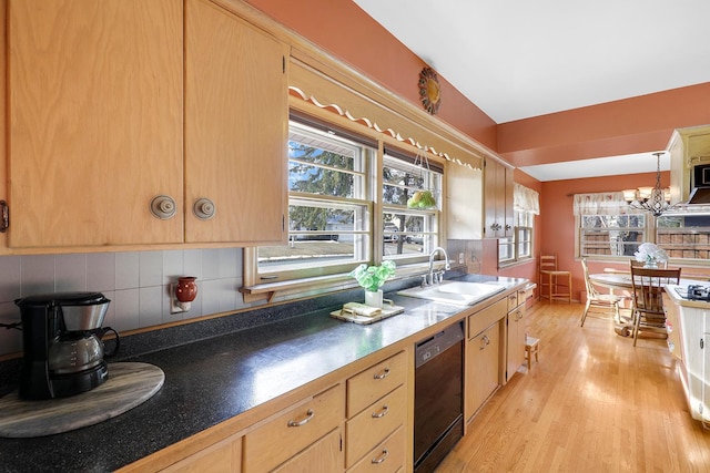 kitchen featuring light brown cabinets, a sink, black dishwasher, light wood finished floors, and decorative backsplash