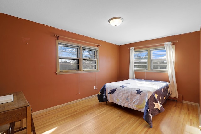 bedroom featuring light wood-style flooring and baseboards