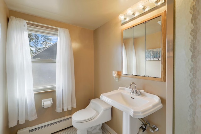 half bath featuring baseboard heating and toilet