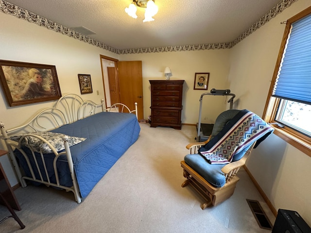 bedroom featuring carpet and a textured ceiling