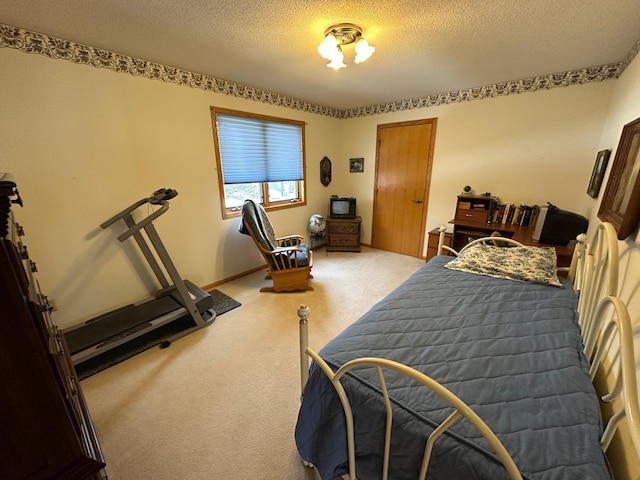 carpeted bedroom with a textured ceiling