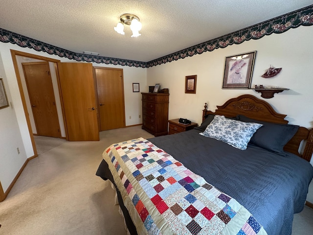 carpeted bedroom featuring a textured ceiling