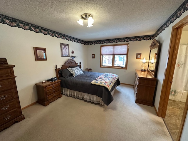 bedroom with light carpet and a textured ceiling