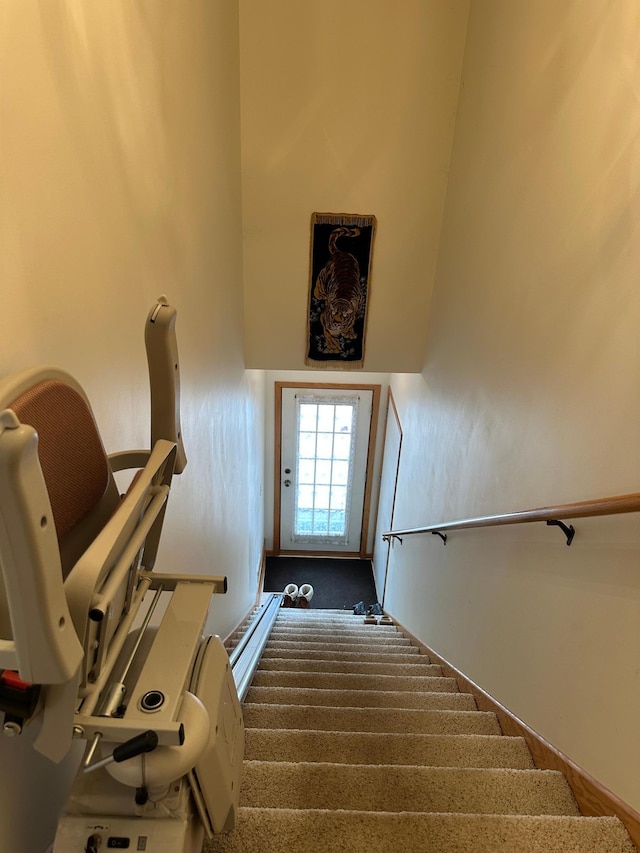 stairs featuring a towering ceiling