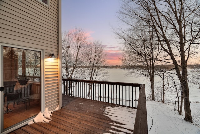 snow covered deck featuring a water view