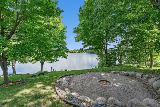 16091 Northwood Rd NW, Prior Lake, MN 55372 - view of grassy yard featuring a water view, a fire pit, and a patio