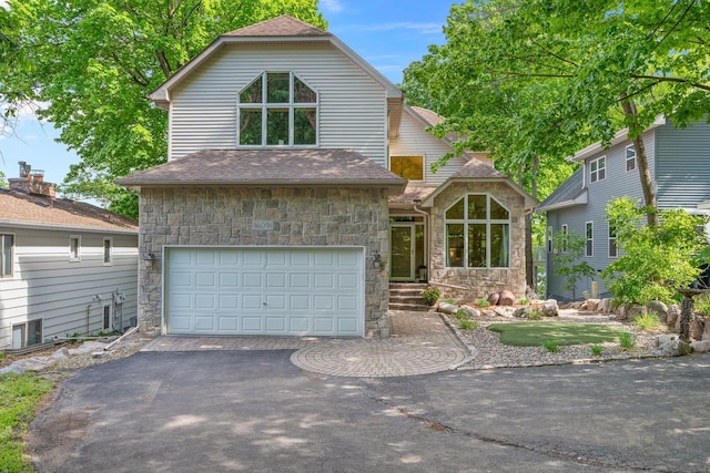 16091 Northwood Rd NW, Prior Lake, MN 55372 - view of front facade with stone siding, an attached garage, and asphalt driveway
