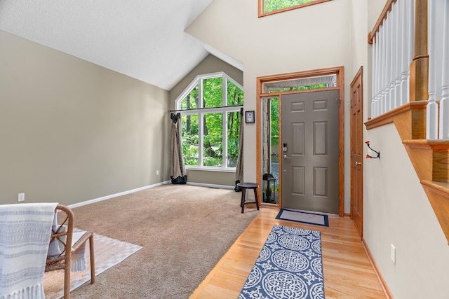 16091 Northwood Rd NW, Prior Lake, MN 55372 - entrance foyer featuring light wood-type flooring, stairs, and high vaulted ceiling