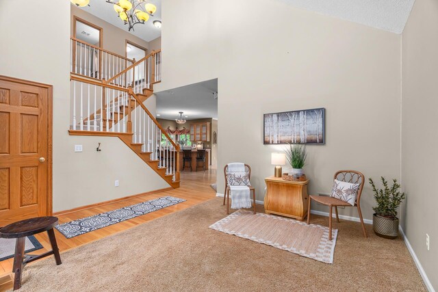 16091 Northwood Rd NW, Prior Lake, MN 55372 - living area featuring a chandelier, stairway, a high ceiling, and carpet floors