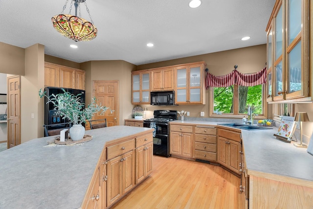 16091 Northwood Rd NW, Prior Lake, MN 55372 - kitchen with black appliances, light countertops, light wood-style floors, decorative light fixtures, and recessed lighting