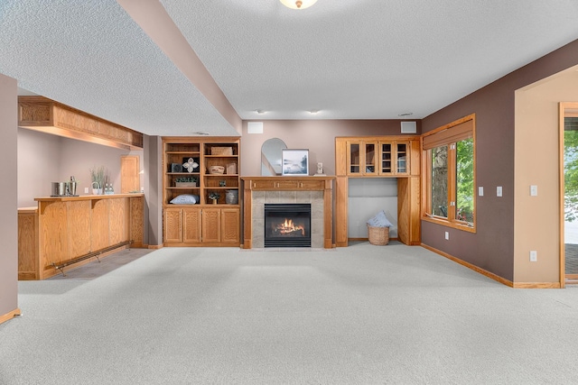 16091 Northwood Rd NW, Prior Lake, MN 55372 - unfurnished living room with a textured ceiling, carpet flooring, a fireplace, and built in shelves