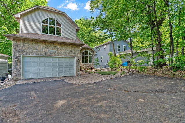 16091 Northwood Rd NW, Prior Lake, MN 55372 - view of front facade with stone siding, a garage, and driveway