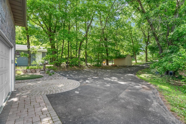 16091 Northwood Rd NW, Prior Lake, MN 55372 - view of patio / terrace with a storage unit and driveway