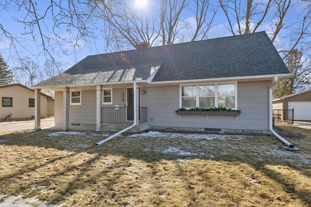 view of front of home featuring a chimney, roof with shingles, crawl space, covered porch, and a front lawn