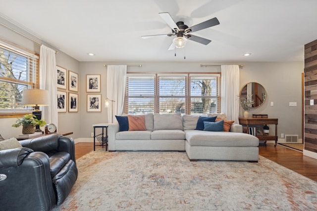 living area featuring plenty of natural light, wood finished floors, and recessed lighting