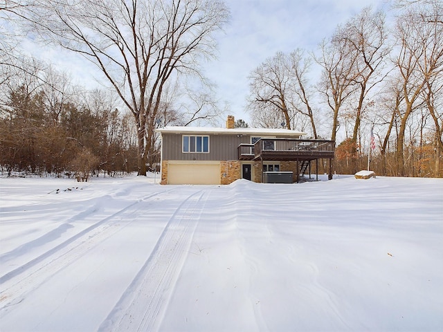 exterior space featuring a wooden deck and a garage