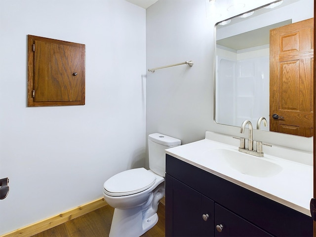 bathroom featuring vanity, hardwood / wood-style floors, and toilet