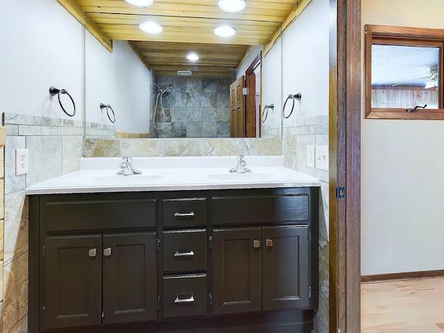 bathroom with wood ceiling, vanity, and tile walls