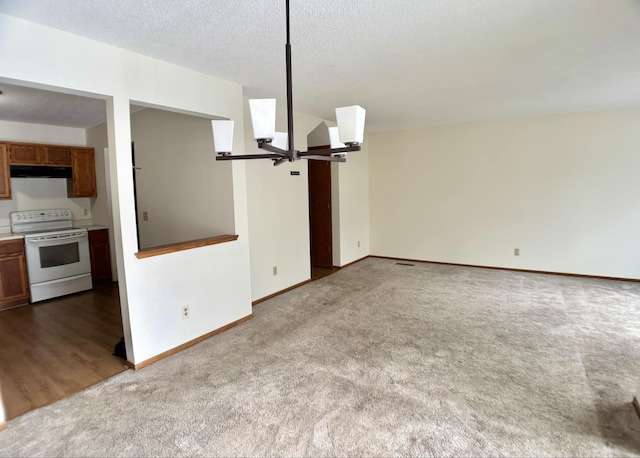 unfurnished living room with carpet and a textured ceiling