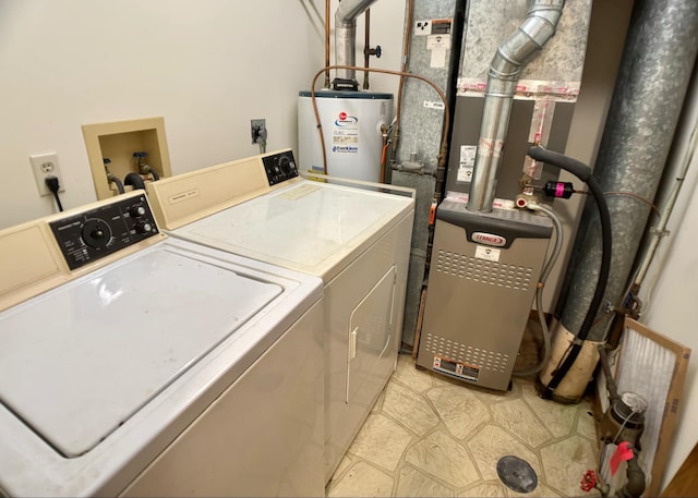 clothes washing area with water heater and washing machine and clothes dryer