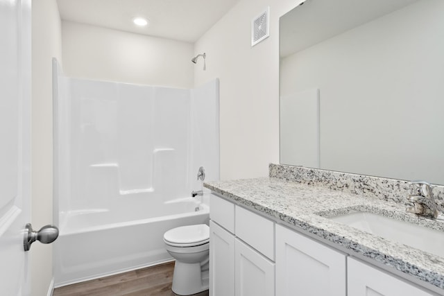 full bathroom with hardwood / wood-style flooring, shower / tub combination, vanity, and toilet