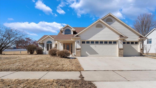 view of front of house with an attached garage, brick siding, and driveway