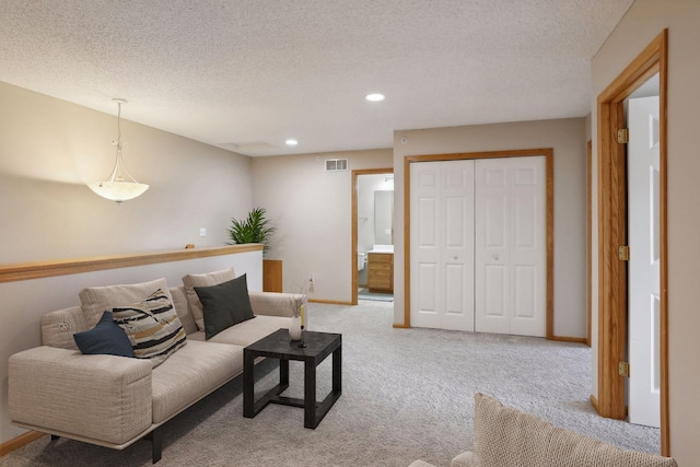 living room with light colored carpet and a textured ceiling