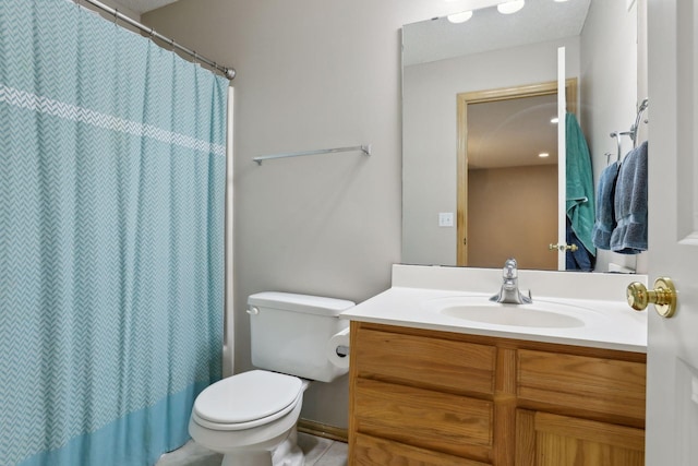 bathroom featuring tile patterned flooring, vanity, and toilet