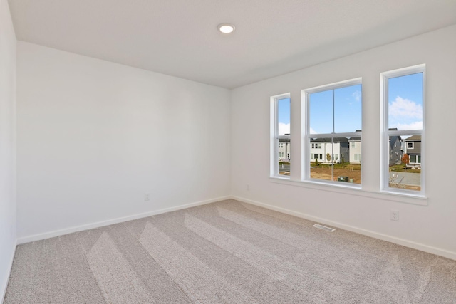 carpeted empty room with a wealth of natural light