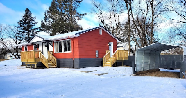 view of snow covered exterior featuring a detached carport