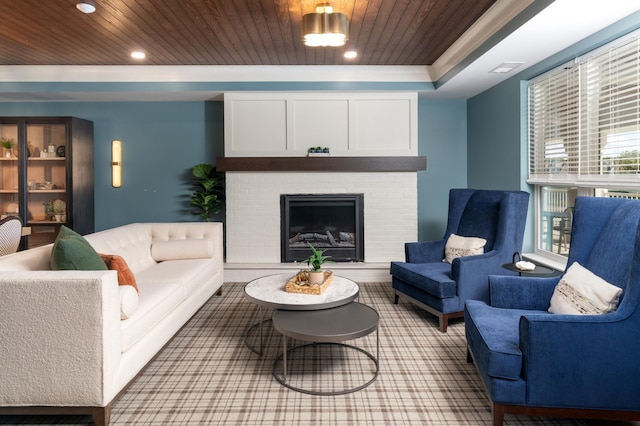 living room featuring a brick fireplace, a tray ceiling, ornamental molding, and wooden ceiling