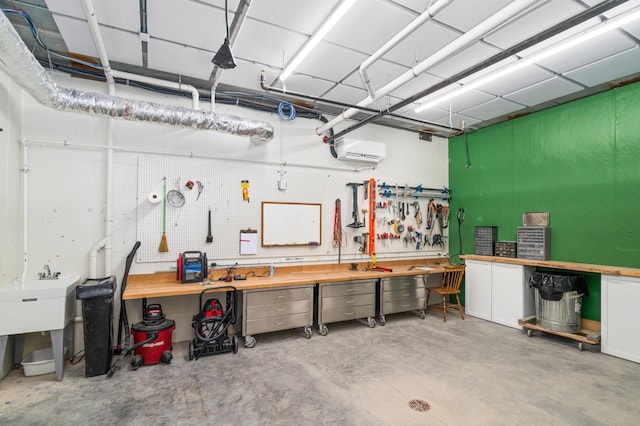 garage featuring a wall mounted AC and a workshop area