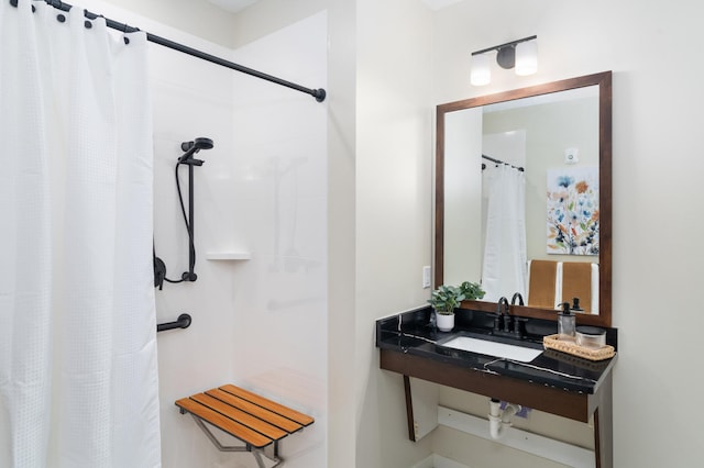 bathroom with curtained shower and sink