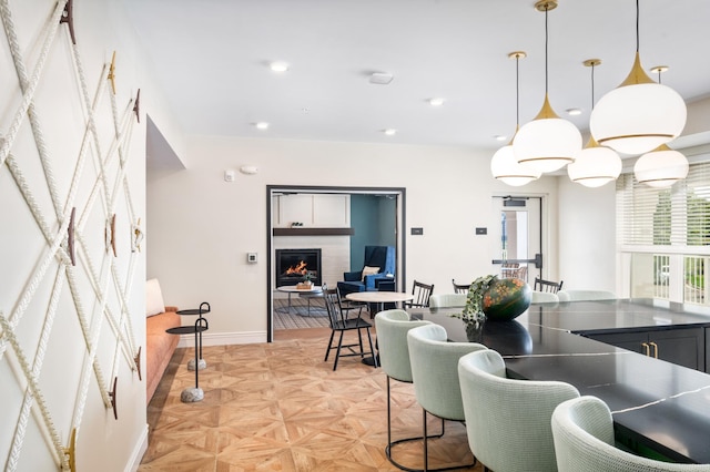 kitchen featuring light parquet floors and decorative light fixtures