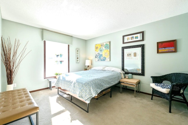 bedroom with light carpet, a textured ceiling, and baseboards