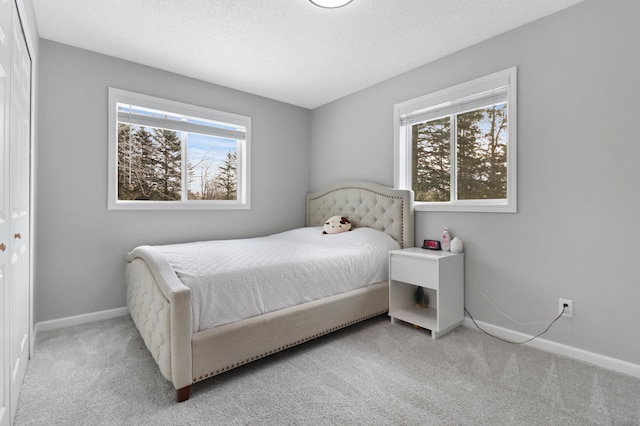 carpeted bedroom featuring a textured ceiling