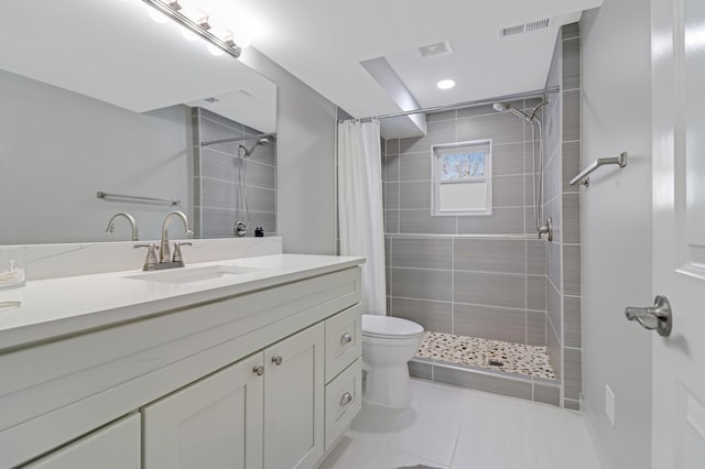 bathroom with vanity, tile patterned flooring, toilet, and walk in shower