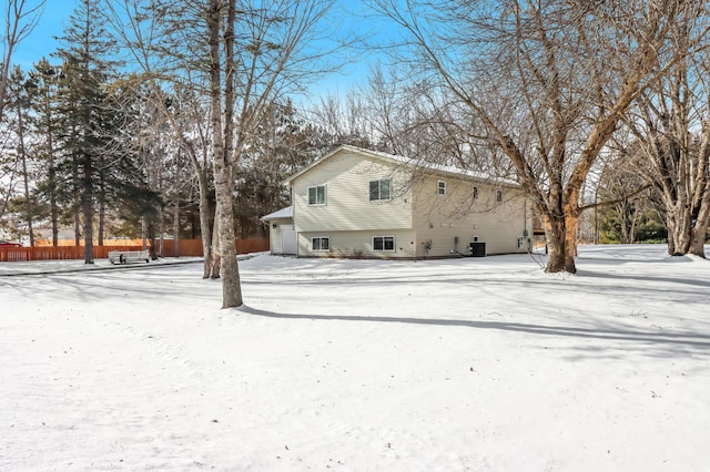 view of snow covered back of property