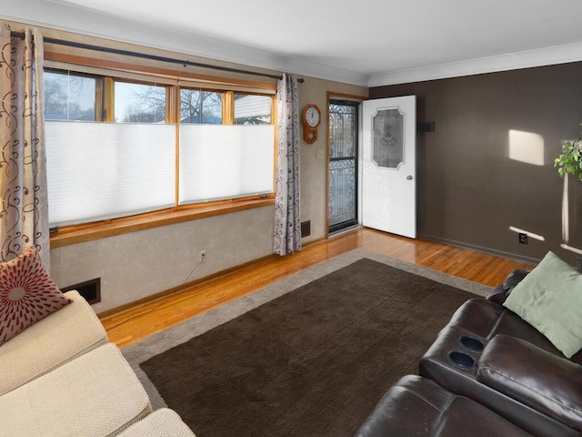 living room with crown molding and hardwood / wood-style floors