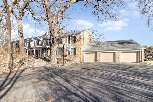 view of front facade featuring a garage and brick siding