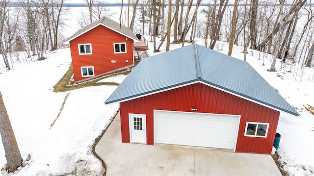 snow covered garage with a garage