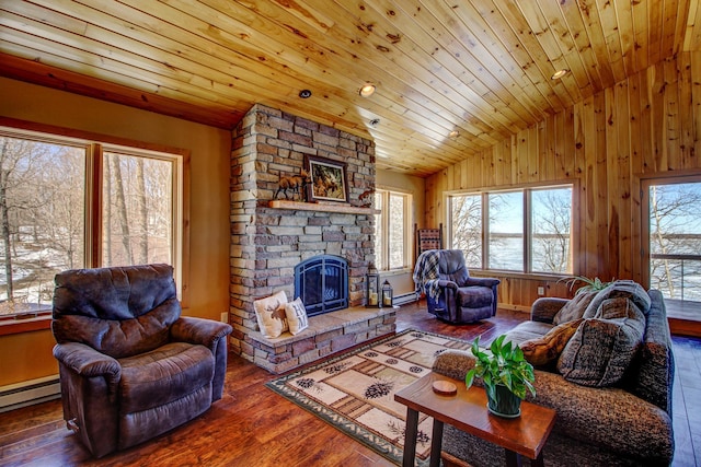 living room with a baseboard heating unit, wood-type flooring, wooden ceiling, a fireplace, and vaulted ceiling