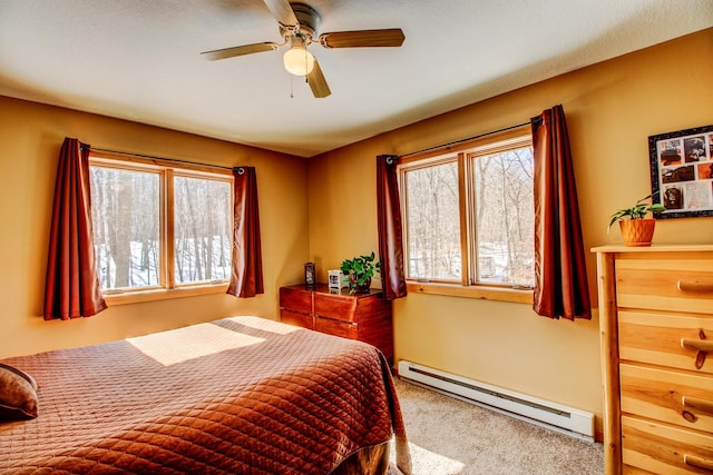 bedroom with a baseboard radiator, carpet, and ceiling fan