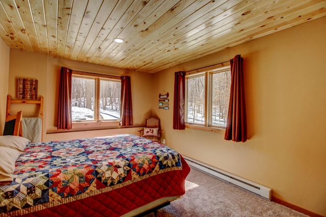 bedroom featuring a baseboard heating unit, wooden ceiling, carpet flooring, and baseboards