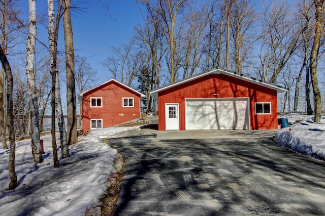 snow covered garage featuring a garage